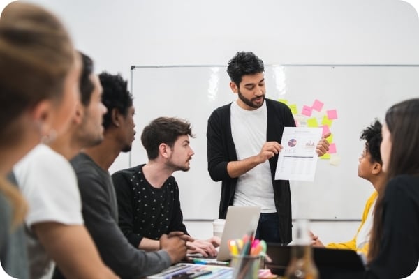 Man presenting report in team meeting
